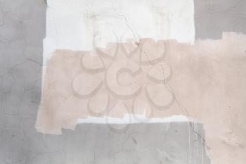 Concrete wall with white and pink paint layers, close-up background texture