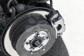 Replacing wheel on modern suv car, close-up photo of shiny brake disk
