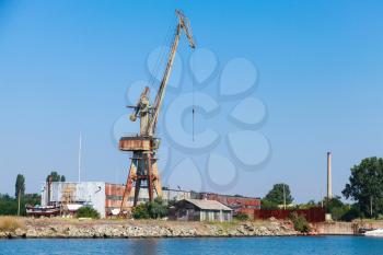 Port crane stands on the Black Sea coast in Burgas port, Bulgaria