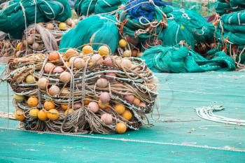 Drying fishing nets with orange floats lay on the sea coast in port of Busan. South Korea