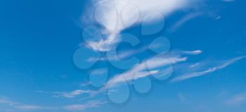 Blue sky with windy cirrus clouds at daytime. Natural panoramic background photo texture