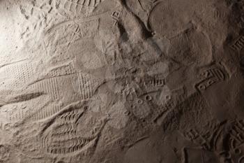 Footprints in dark gray dusty ground, background photo texture