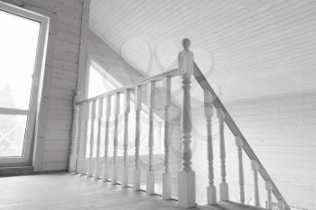 White balcony railings. New wooden house interior feagment