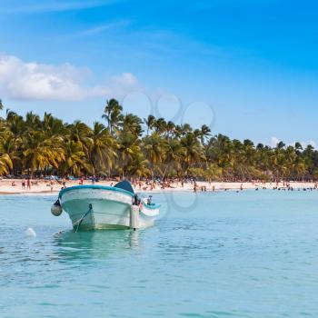 Pleasure boat moored near sandy beach of Saona island. Caribbean Sea coast, Dominican republic