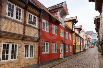 Colorful living houses in a row along the street in old town of Flensburg, Germany