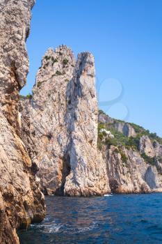 Coastal vertical landscape with rocks of Capri island, Mediterranean Sea coast, Italy