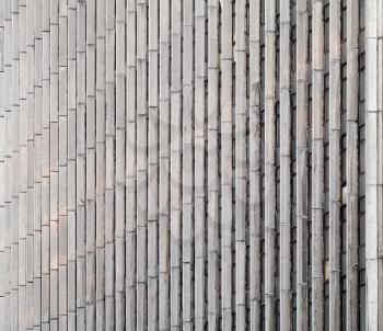 Abstract architecture background. Concrete wall with vertical lines and windows