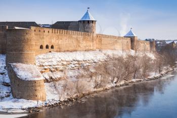 Ivangorod fortress at Narva river in winter. Border between Russia and Estonia