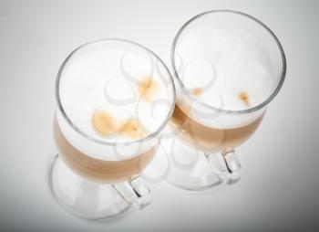Two glasses of latte coffee with milk foam