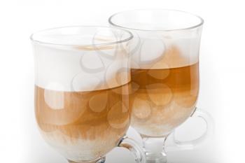 Two big mugs with handles of latte coffee, macro photo