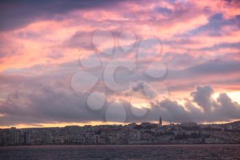 Bright red sunset sky over Tangier city, Morocco. Bright tonal correction photo filter effect