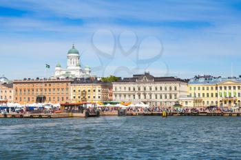 Helsinki cityscape. Central quay, building facades and dome of the main city cathedral on a background