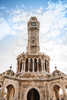 Historical clock tower under cloudy sky, it was built in 1901 and accepted as the official symbol of Izmir City, Turkey