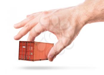 Bright red metal freight shipping container in man's hand isolated on white