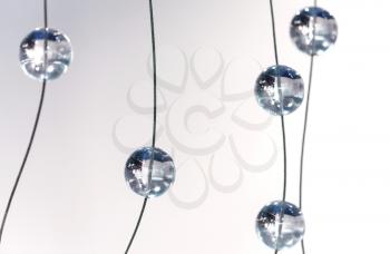 Abstract monochrome background with glass spherical design elements of modern chandelier