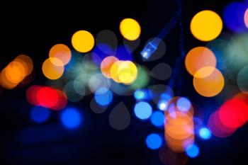 Colorful LED (light emitting diodes) lights garland with bokeh effect on black background
