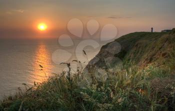 Normandy sunset landscape with herbal on the coast
