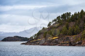 Spring Norwegian coastal landscape with sea and dark mountains