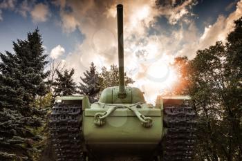 Soviet heavy KV-85 tank from the Second World War with forest and dramatic sky on a background. Monument in St-Petersburg