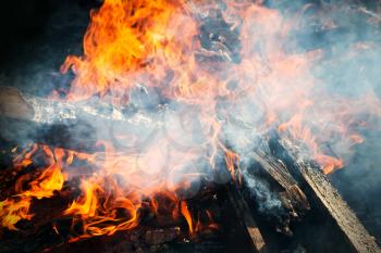 Closeup photo of big outdoor bonfire with smoke