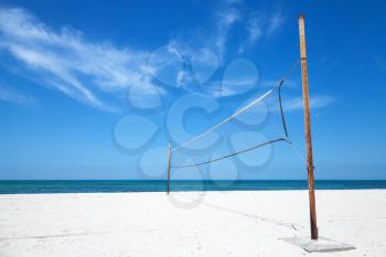 Old net for beach volleyball on empty sea coast