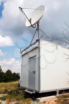 White satellite plate antenna of small observation station