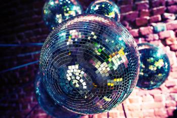 Colorful disco party background with mirror balls reflecting lights