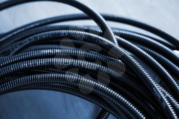 Bundle of Black plastic cable channel. Blue toned photo
