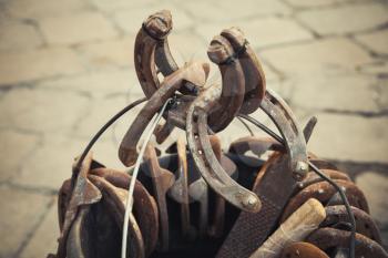 Large group of old steel rusted horseshoes, vintage tonal correction filter, old style photo