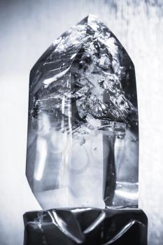 Blue toned photo of natural transparent quartz crystal, selective focus