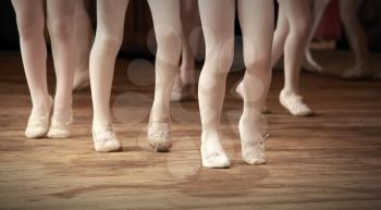 The ballet school fragment with little girls legs on pointes