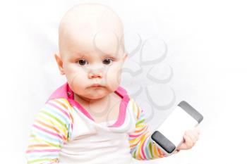 Little baby in casual colorful striped clothing holds mobile phone
