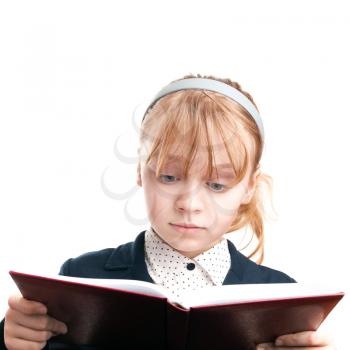Closeup portrait of blond Caucasian schoolgirl reading book isolated on white 