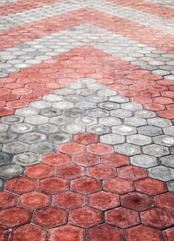 Abstract background texture of cobblestone paving road with red and gray arrows