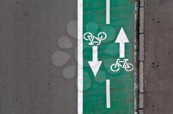 Green bicycle lane with road marking background texture