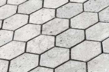 Background texture of gray honeycomb shaped cobblestone road