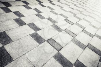 Gray concrete tiling with abstract pattern, urban pavement, background photo texture