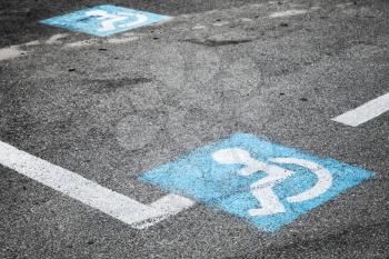 Road marking of place for disabled persons on urban parking lot