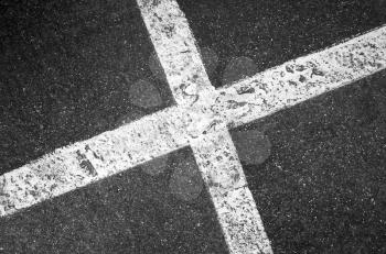 Crossing white lines on black asphalt, parking lot marking