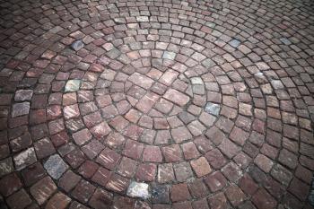 Round element of granite cobblestone road. Background texture