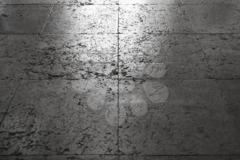 Shining ancient gray stone floor tiling, background texture with perspective effect and selective focus on a foreground
