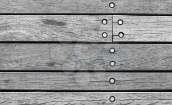Gray wooden wall made of boards with bolts, background photo texture