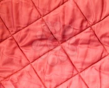 Closeup background texture of quilted red blanket fabric