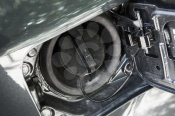 Modern car details, closed fuel cap. Closeup photo with selective focus