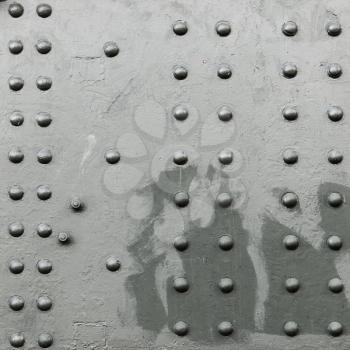 Square abstract dark gray industrial metal background texture with rivets