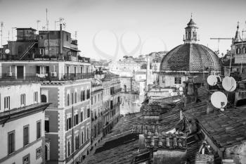 Old Rome, Italy. Via del Corso street view, black and white photo taken from the roof, looking on The Piazza del Popolo with dome of Basilica Santa Maria di Montesanto as a dominant landmark