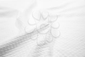 White cotton fabric texture, background photo of wavy blanket