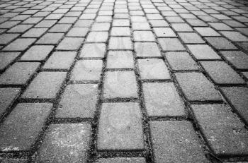 Gray cobble road background photo with perspective effect and selective focus