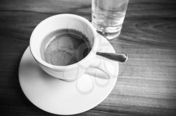 Cup of espresso coffee, black and white photo with selective focus