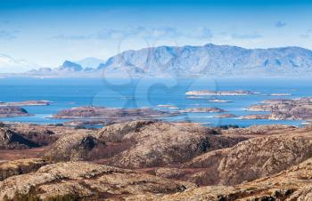 Empty Norwegian coastal landscape with sea, sky and mountains on horizon